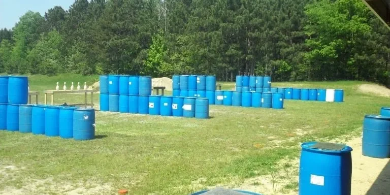 A field with many blue barrels in it